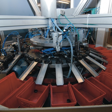 Precision-turned parts are fed more quickly to the testing stations